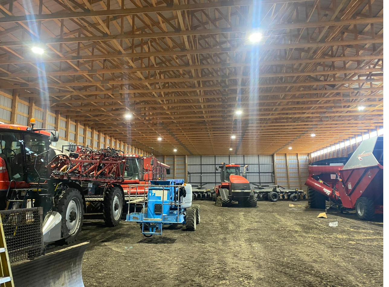 Large farm machine shed with overhead LED lighting